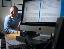 Sound engineer, musician, artist, actor: Dan Perelstein ’10 sits at computer.